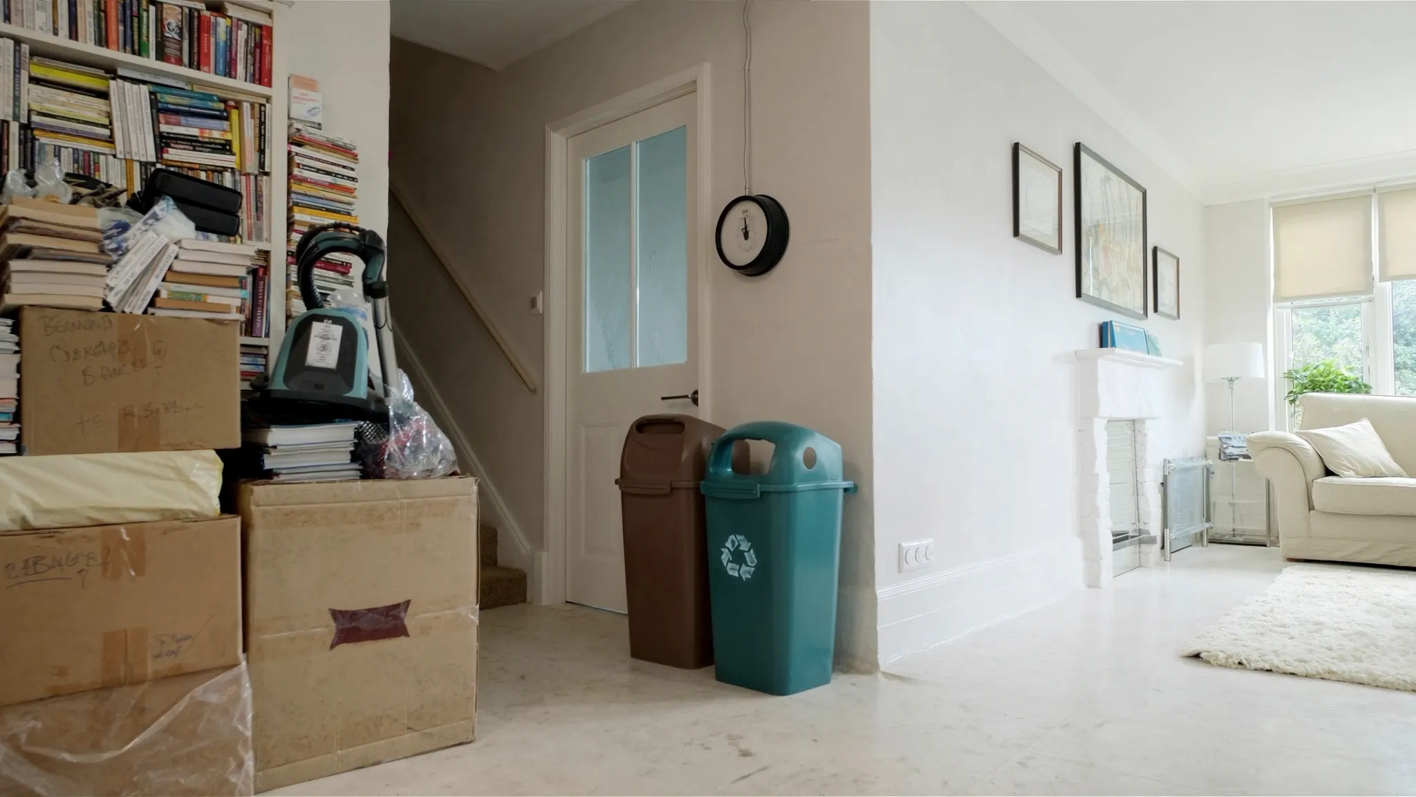 Illustrative concept image: one side of a living room stacked with books and boxes, the other side already cleared, clean and calm